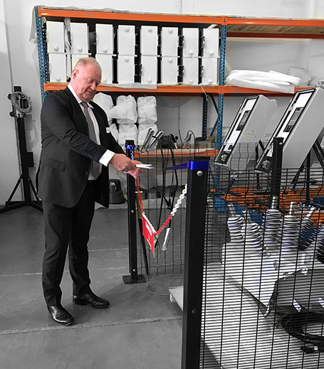 NOJA Power Group Managing Director Neil O’Sullivan cuts the ribbon opening the new RWW NOJA Power Production Line in Laser Park South Africa.